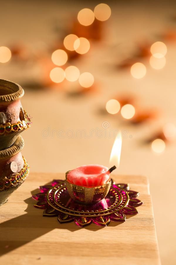 a lit candle on a wooden table with candles in the background royalty images and clippings