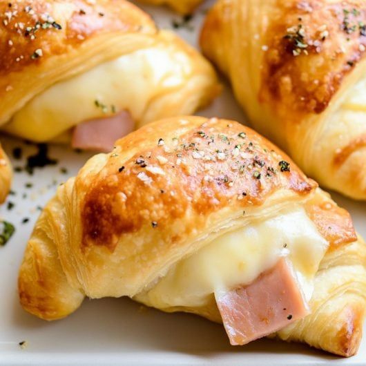 ham and cheese pastries on a white plate