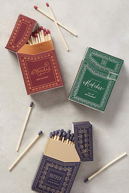 three matches are lined up on a table next to two boxes and one box with matches