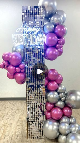 a birthday decoration made out of balloons