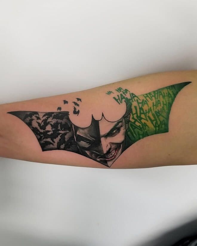 a batman tattoo on the arm with green ink