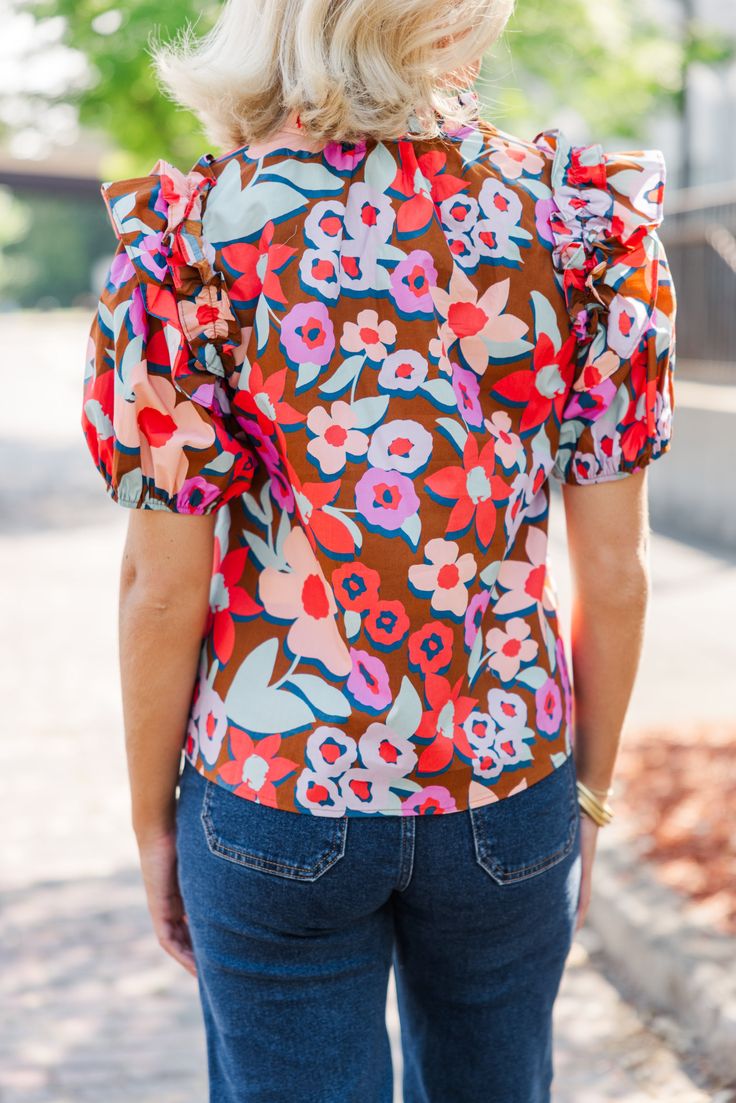 This floral blouse is such a must have! That print is super bold and fun! Plus, we love that ruffled detailing along the shoulders! V-neckline Short bubble sleeves Ruffled detailing Floral print No stretch Payton is wearing the small. Chic Printed Blouse With Flutter Sleeves, Spring Floral Print Flutter Sleeve Blouse, Fitted V-neck Blouse In Multicolor Print, Fitted V-neck Blouse With Vibrant Print, Chic Spring All Over Print Tops, Chic All Over Print Spring Tops, Chic Spring Tops With All Over Print, Chic All Over Print Tops For Spring, Chic Flutter Sleeve Floral Print Tops