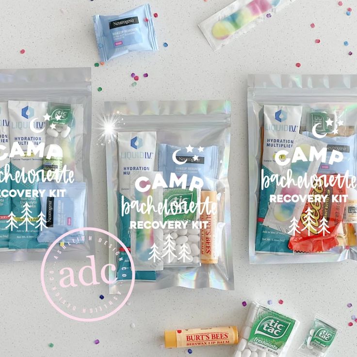 three bags filled with different types of items on top of a white table next to confetti and candy