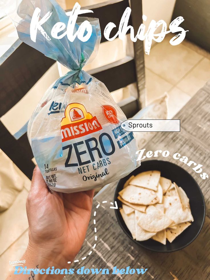 a person holding a bag of chips in front of a bowl of tortilla chips