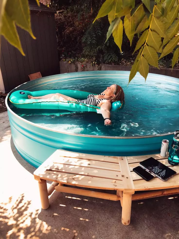 a woman laying on an inflatable pool