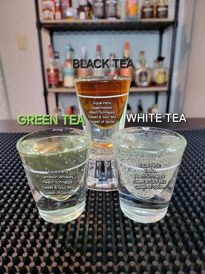 three glasses with different types of green tea and white tea sitting on top of a table