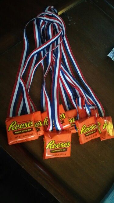 four reese's candy bars on a table with ribbons around them, ready to be eaten