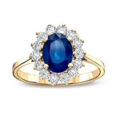 a yellow gold ring with an oval blue sapphire surrounded by white and clear diamonds on the band