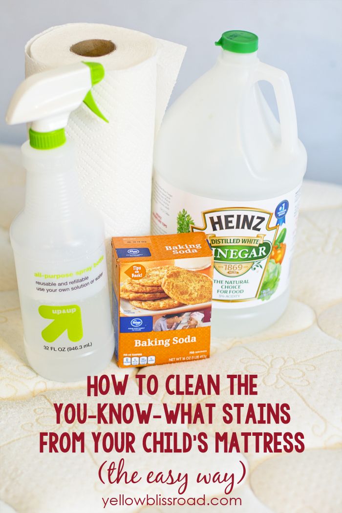 two bottles of cleaning products sitting on top of a bed