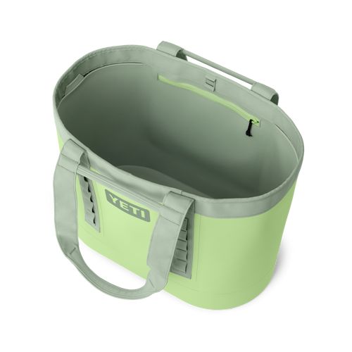 a green cooler bag sitting on top of a white surface