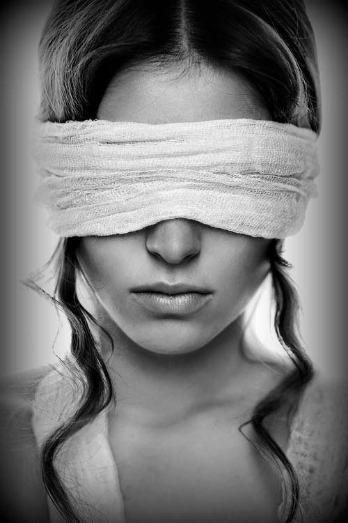 a woman with bandages on her head and blind folded over her eyes is shown in this black and white photo