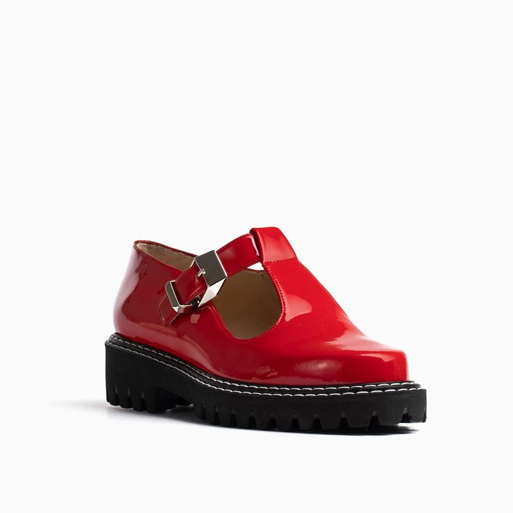 This red patent lug sole shoe is designed for women who are looking for a comfortable mary jane silhouette with a kick. A silhouette crafted of a sturdy sole and extra cushioned ensures walkability. While it contrast stitching and modern buckle is sure to catch an eye. Patent upper with leather lining Extra cushioned insole Elasticized adjustable strap Rubber lug sole 1.5 inch heel + .75 inch platform Made in Spain. Flat Sandals With Buckle Closure, Flat Sandals With Buckle Closure Medium Width, Flat Sandals With Buckle Closure And Medium Width, Flat Patent Leather Sandals With Removable Insole, Casual Patent Leather Sandals With Removable Insole, Casual Patent Leather Sandals With Buckle Closure, Patent Leather Sandals With Buckle Closure And Round Toe, Trendy Closed Toe Footbed Sandals With Buckle Closure, Casual Flat Heel Patent Leather Sandals