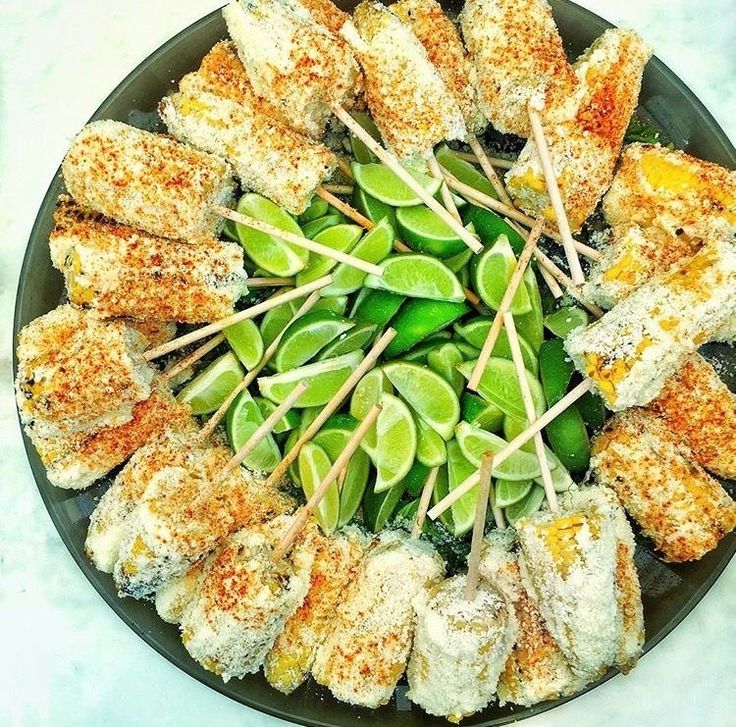 a plate filled with skewered food on top of a table