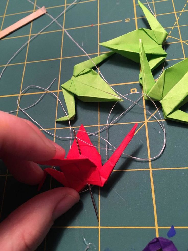 someone is making origami birds out of paper