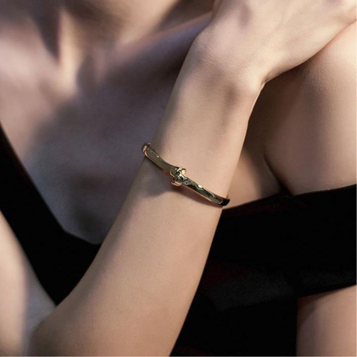 Our Love Knot Cuff is a representation of everlasting love. Crafted from 316L surgical stainless steel and coated with 14K gold PVD plating, our pieces are sure to last. Gold/Rose gold: Inner diameter 2.28"; Inner circumference 6.5" (Adjustable) Silver: Inner diameter 2.13"; Inner circumference 6" (Adjustable) Gold Stainless Steel Cuff Bracelet, Tarnish Resistant, Minimalist Gold Metal Cuff Bracelet, Gold Tarnish-resistant Stainless Steel Cuff Bracelet, Gold Stainless Steel Tarnish-resistant Cuff Bracelet, Gold-tone Metal Cuff Bracelet, Tarnish Resistant, Gold Bangle With Oyster Bracelet For Anniversary, Promise Bracelet In Gold-toned Stainless Steel, Gold-tone Tarnish Resistant Cuff Bracelet For Gift, Gold-tone Tarnish Resistant Cuff Bracelet