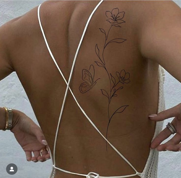 the back of a woman's body with flowers on it