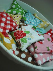 a white bowl filled with lots of different colored pillows