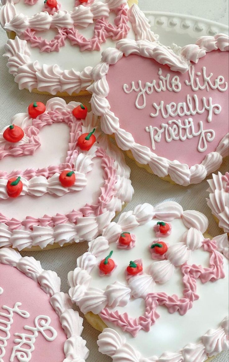 decorated heart shaped cookies with writing on them