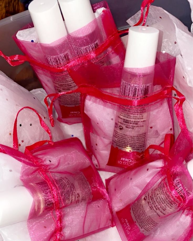 several bottles with pink ribbon wrapped around them