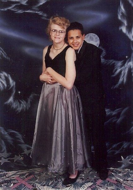 two people in formal wear posing for a photo