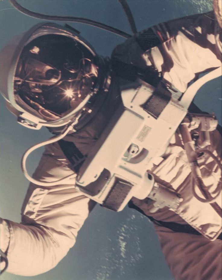 an astronaut in the outer space with his helmet on