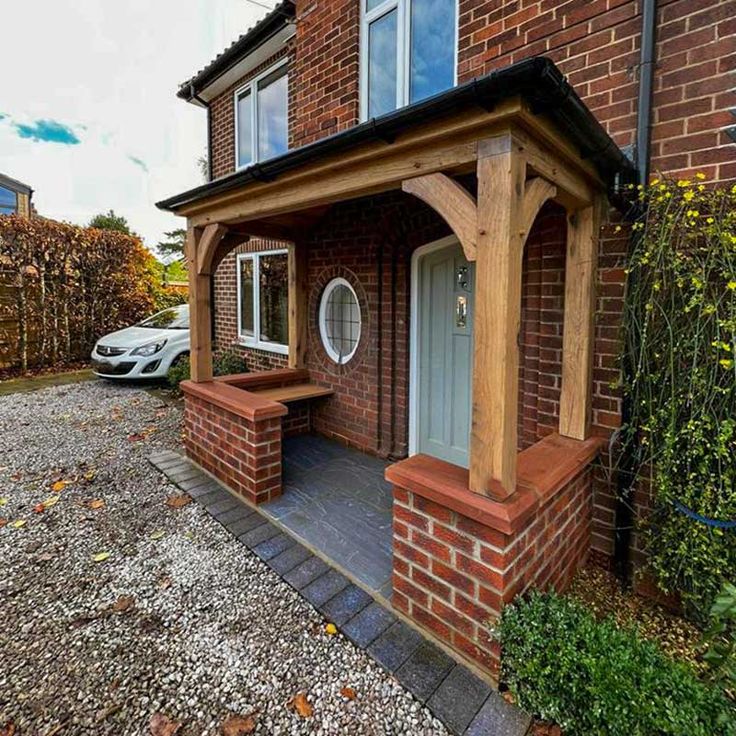 a house with a car parked in front of it and some bushes on the side