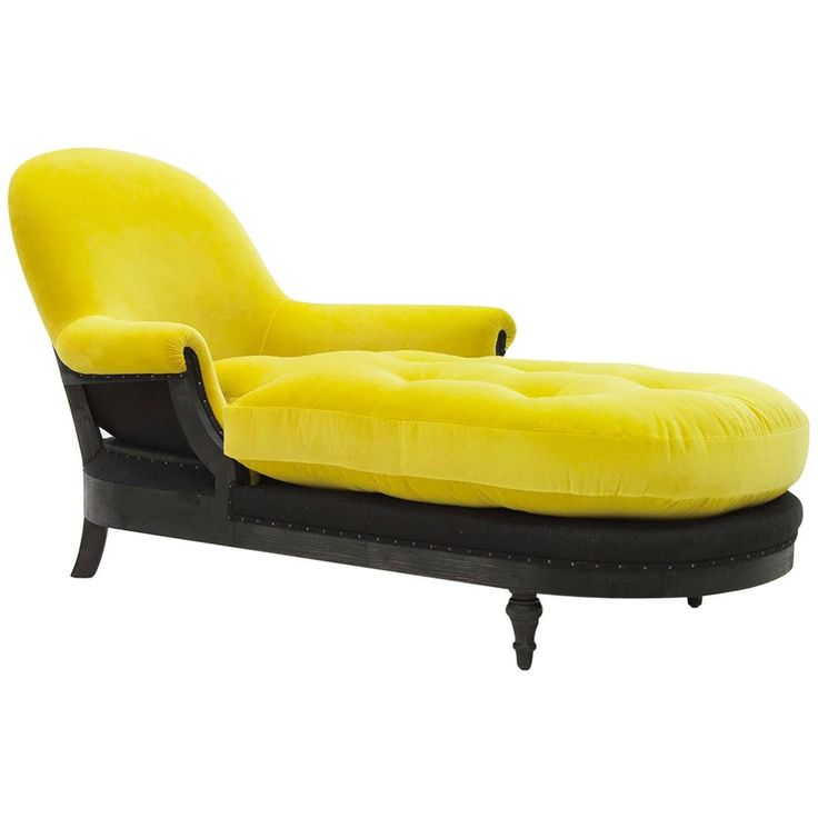 a yellow chaise lounge chair sitting on top of a black base and foot rest