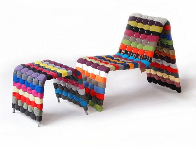 a multicolored bench made out of strips of paper