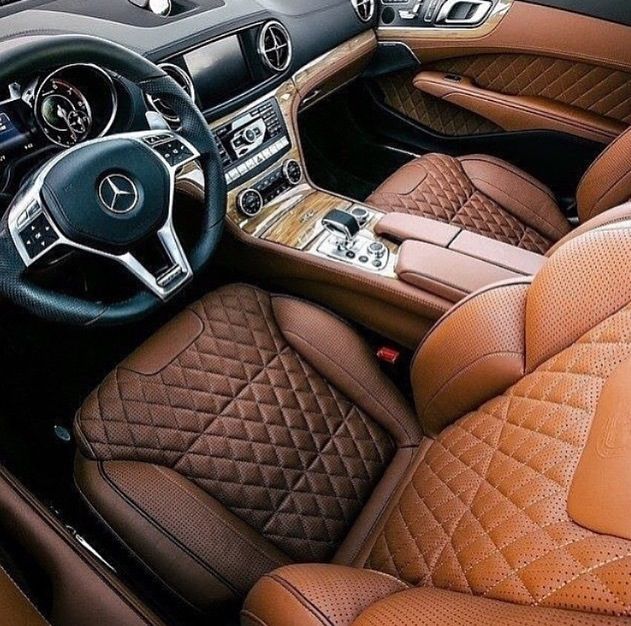 the interior of a car with tan leather and brown stitching on the floor mats