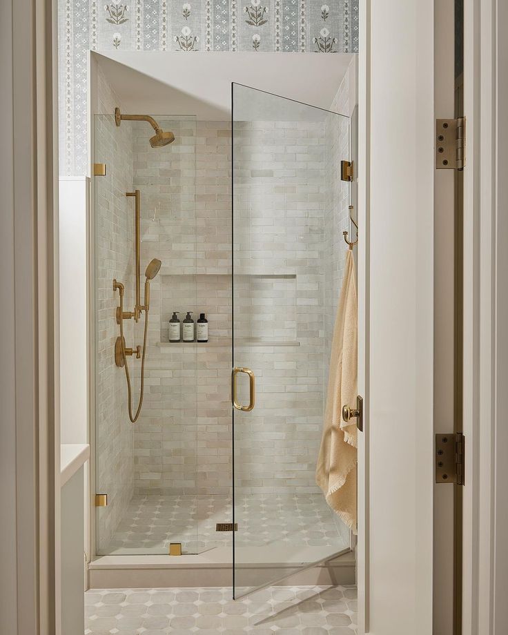 a walk in shower sitting inside of a bathroom