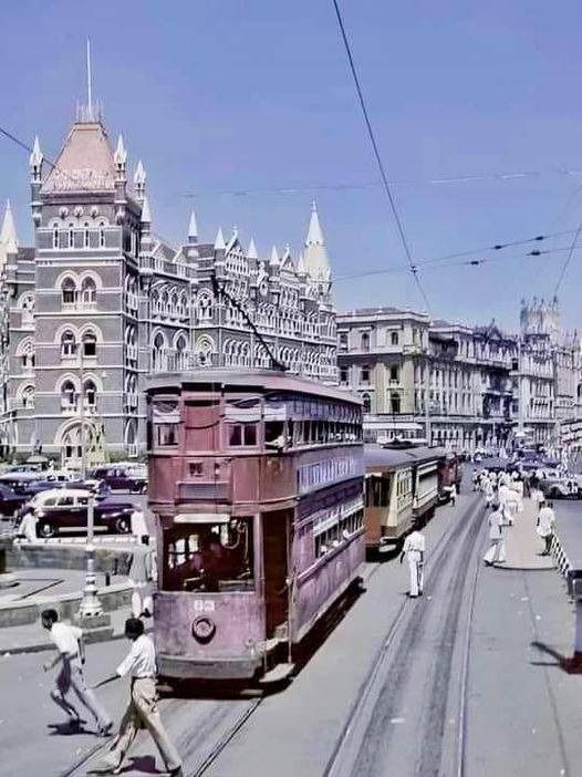 an old photo of people walking on the street