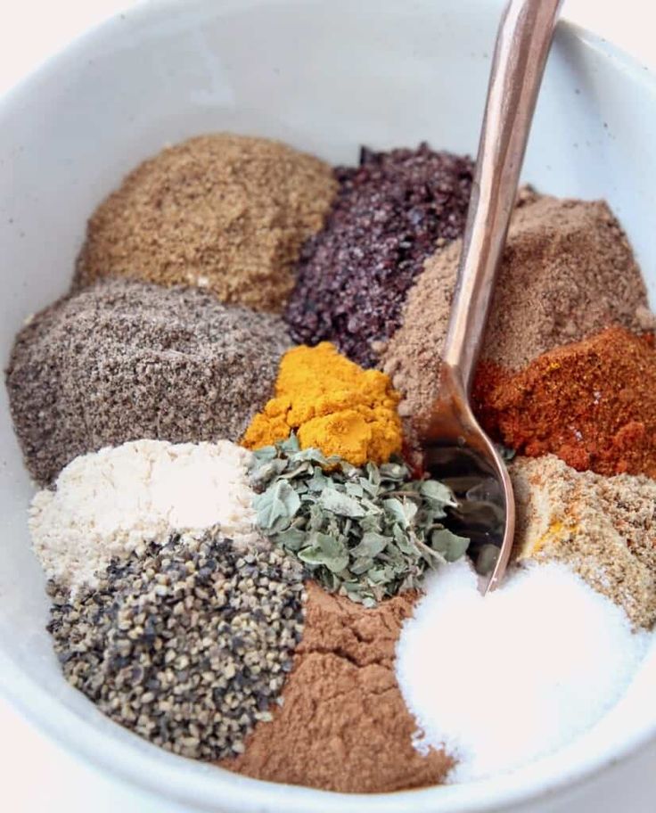 a white bowl filled with different types of spices