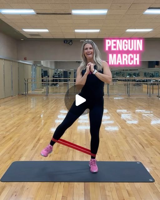 a woman standing on a yoga mat with the words penguin march in front of her