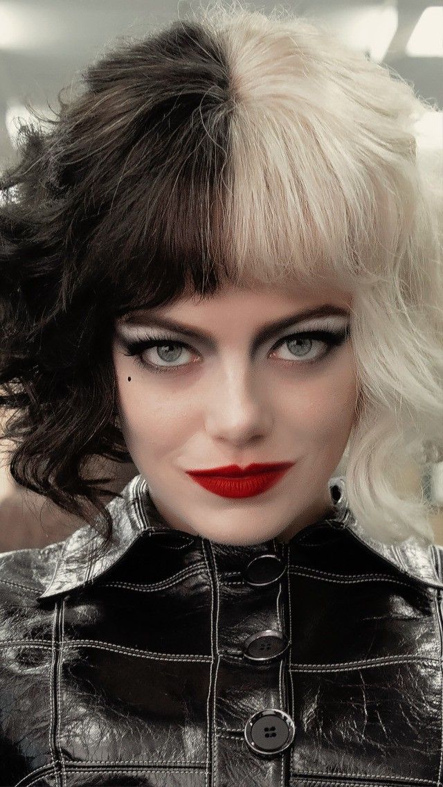 a close up of a woman with short hair and red lipstick on her face, wearing a black leather jacket