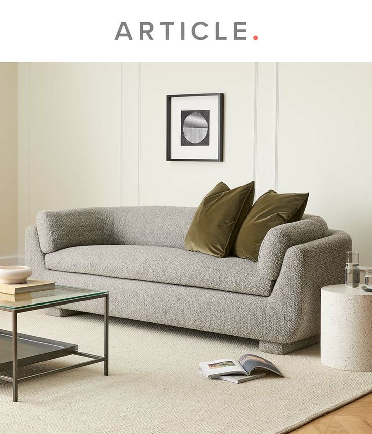 a living room scene with focus on the couch and coffee table in the foreground