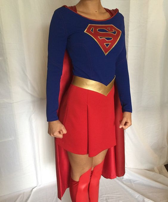 a woman in a red skirt and blue shirt is dressed up as a supergirl