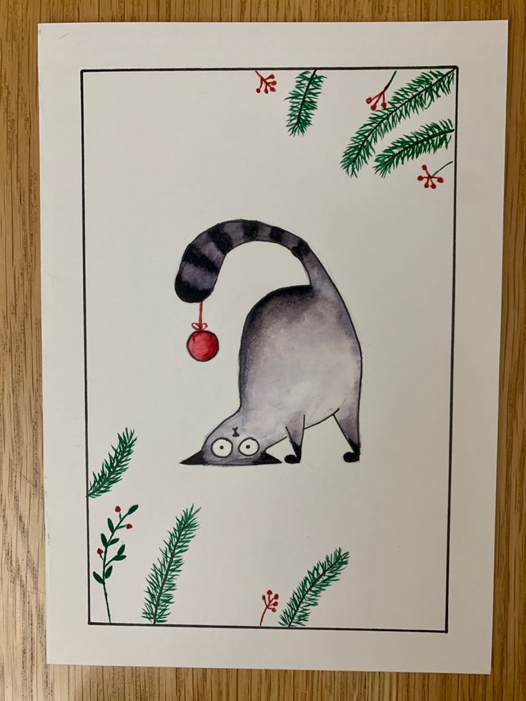 a card with an image of a raccoon holding a christmas ornament