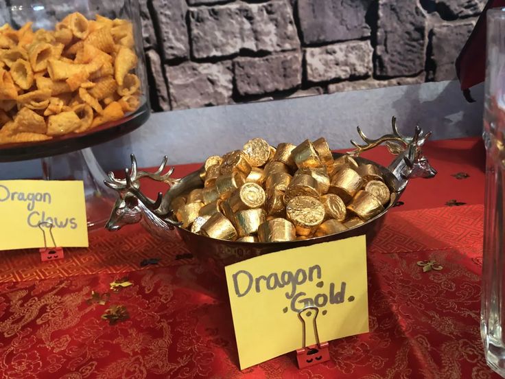 a table topped with lots of food on top of a red table cloth