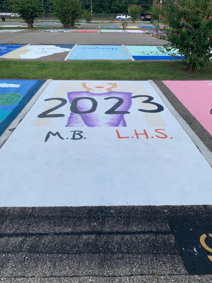 Parking Spot painted to look like polaroid cover of Taylor Swift album “1989”. Instead of “1989” is it 2023 for graduation year. Taylor swift in purple sweater with red lipstick, simplified figure in the background. Taylor Swift Painted Parking Spot, Senior Parking Space Taylor Swift, Painted Parking Spots Taylor Swift, Parking Spot Chalk Ideas, Barbie Parking Spot, Taylor Swift Parking Spot Painting Ideas, Parking Spot Ideas High School, Senior Parking Space Ideas Taylor Swift, Senior Parking Spaces Taylor Swift