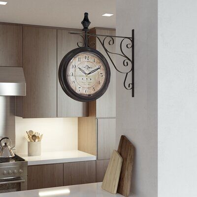 a kitchen with a clock hanging from the wall