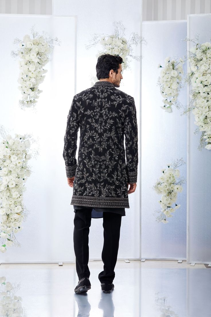 This black short sherwani set features tonal all over zardosi embroidery on a japanese base. It is paired with a black silk kurta and a japanese trouser. Complimenting stole and footwear is also available. From Seema Gujral's Tuscan Summer collection. DELIVERY TIMEPlease allow 4 months for your outfit to arrive.FABRIC DETAILSJapaneseProfessional cleaning only. Black Unstitched Sherwani With Dabka Embroidery, Embroidered Black Sherwani For Party, Semi-formal Black Sherwani With Dabka, Semi-stitched Black Sherwani For Diwali, Black Embroidered Semi-stitched Sherwani, Wedding Outfits For Family Members, Zardosi Embroidery, Men's Wedding Outfit, Men's Suits