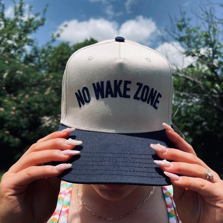 Make a splash with our No Wake Zone Classic Trucker Hat in White/Royal! Perfect for keeping the sun out of your eyes whether you're at the lake, ocean, or poolside. Versatile enough to wear anywhere, this hat adds a touch of fun to any outfit. Dive in and grab yours today! Summer Trucker Hat With Curved Brim For Outdoor, Summer Sports Snapback Dad Hat, Summer Travel Adjustable Snapback Hat, Snapback Sun Hat With Upf 50+ For Summer, Summer Snapback Sun Hat For Outdoor, Summer Sun Hat With Upf 50+ Snapback, Summer Sports Dad Hat With Curved Brim, Summer Snapback Hat For Outdoor Activities, Summer Snapback Hats For Outdoor