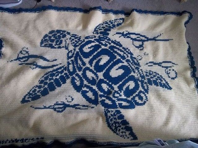 a blue and white blanket with a turtle on it