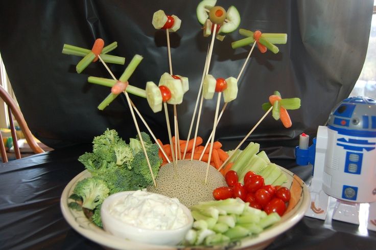 a plate with toothpicks, tomatoes, celery and broccoli