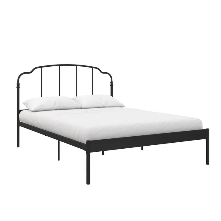 a black metal bed frame with white pillows