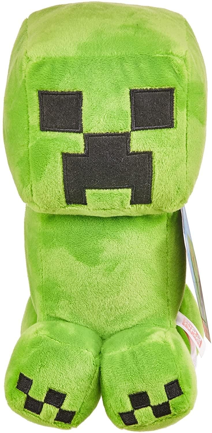 a green minecraft stuffed animal with black eyes and teeth on it's face