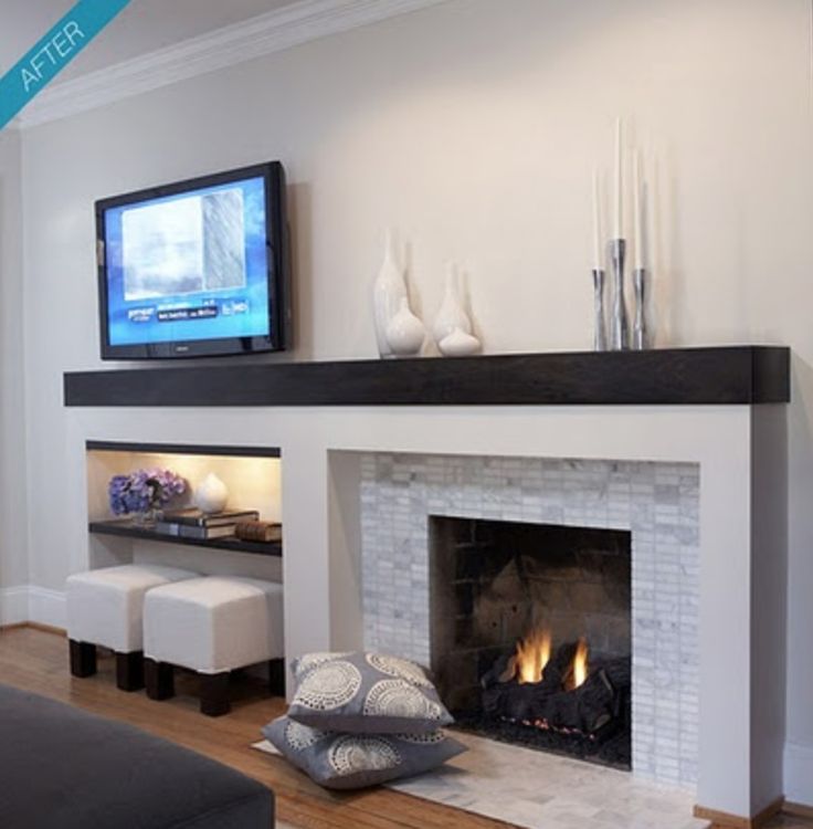 a living room with a fire place and flat screen tv on the wall above it