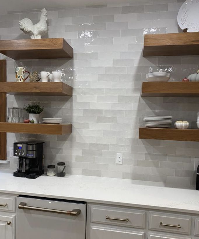 the kitchen is clean and ready to be used for cooking or baking, with open shelving on the wall