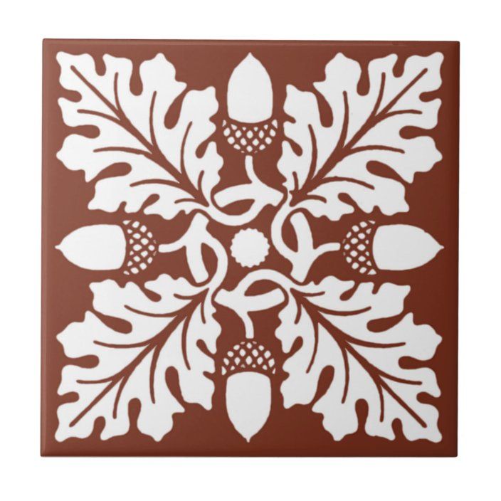 a brown and white tile with leaves on it