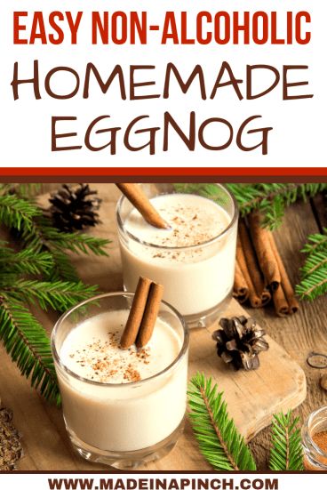 two glasses filled with homemade eggnog on top of a wooden table next to pine cones